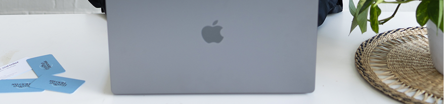 macbook with swoon cards in desk