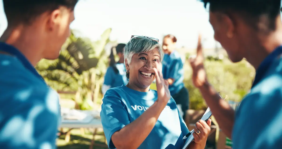 Smiling volunteer giving a high five at a community event